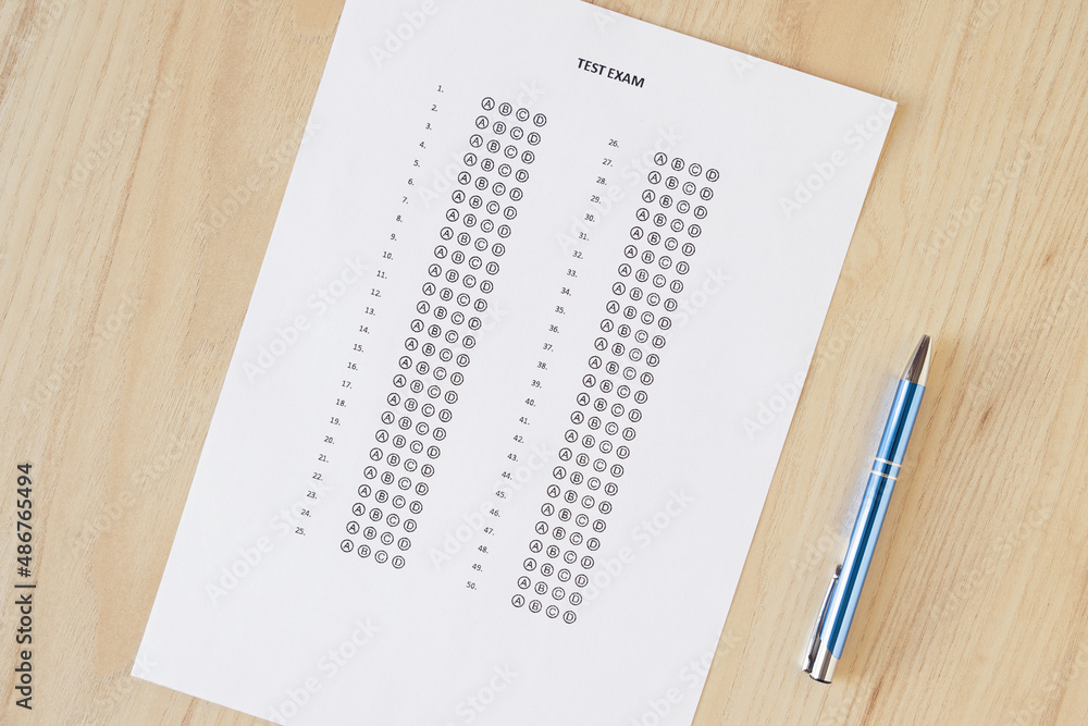 Close up and cropped examination test sheet for school / university writing answer sheets or standardized test form with answers bubbled on the table. multiple choice answer sheet. Flat lay Close up and cropped examination test sheet for school / university writing answer sheets or standardized test form with answers bubbled on the table. multiple choice answer sheet. Flat lay