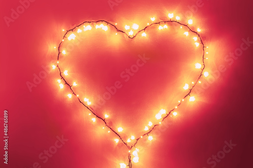 Shining pink heart made from lights  lovely Valentine s day atmosphere