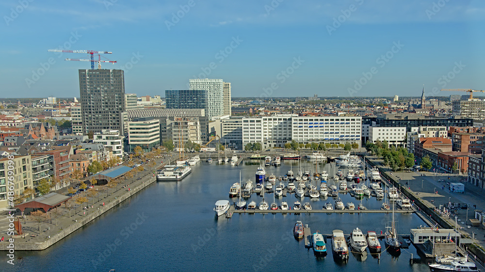 Aerial view on `Willemsdok` dock with leisure boats and surrounding apartment and office buildings in the port Antwerp, Flanders, Belgium 