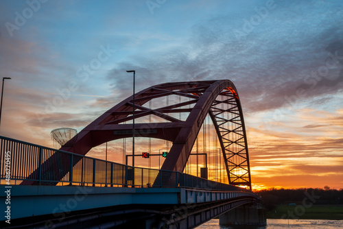 Brücke der Solidarität über den Rhein bei Duisburg am Abend bei Sonnenuntergang photo