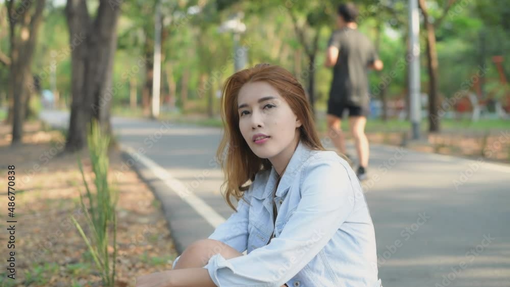 Independent concept of 4k Resolution. Asian woman sitting in the park. Skateboarder lifestyle. Independent concept of 4k Resolution. Asian woman sitting in the park. Skateboarder lifestyle.