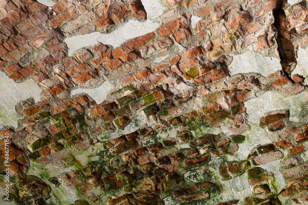 Destroyed colorful brick wall close-up.