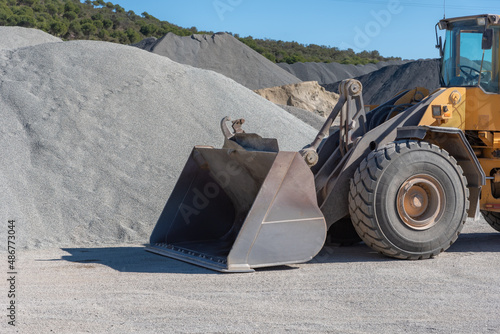 Excavator shovel moving sand in a quarry.