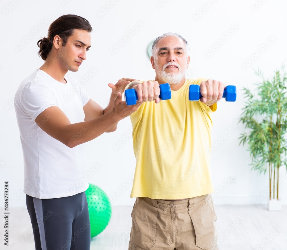 Old man doing exercises indoors Old man doing exercises indoors
