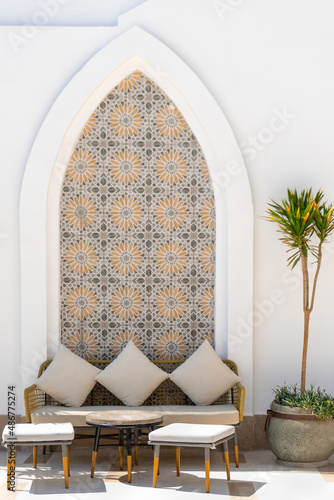 Arabian terrace exterior with sofas, tables, pillows and stools
