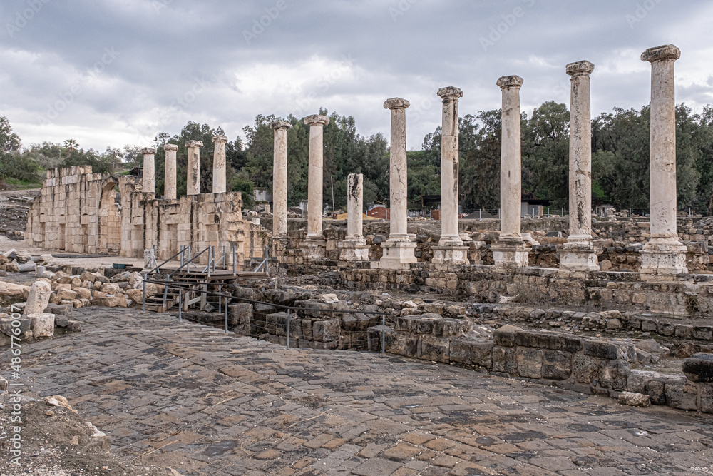 Fototapeta premium View of the Decumanus, east-west oriented street, perpendicular to the Cardo, with a row of columns in the Ancient Roman city in Beit Shean Nationl Park, Jordan Valey, Northern Israel, Israel