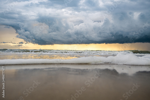 Heavy clouds on the beach at sun set, dark clouds