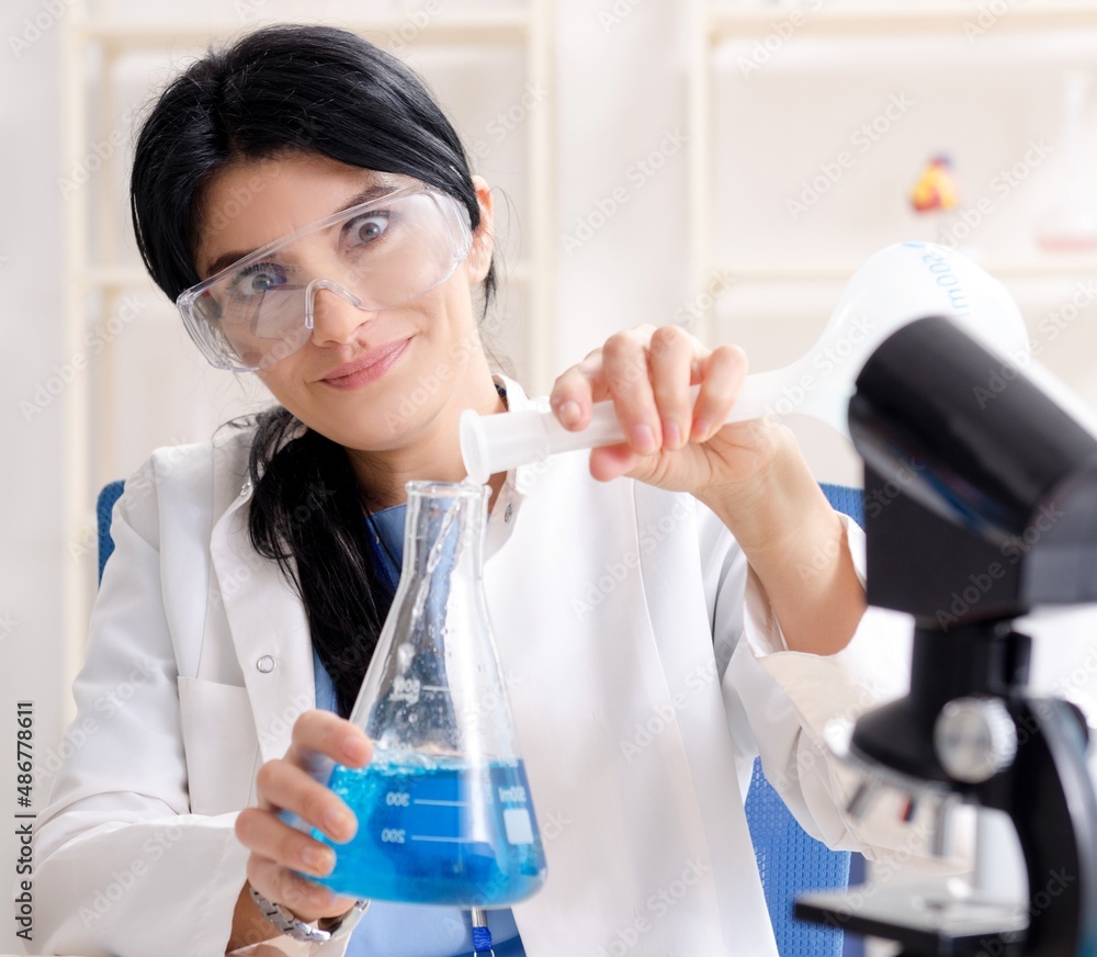 The female chemist working at the lab The female chemist working at the lab