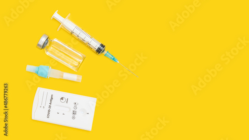 Rapid antigen test kit for viral disease COVID-19, top view on yellow background with copy space