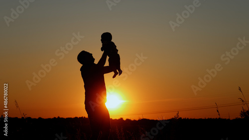 Wallpaper Mural  Happy father throws up his baby, Unrecognizable silhouette at sunset Torontodigital.ca