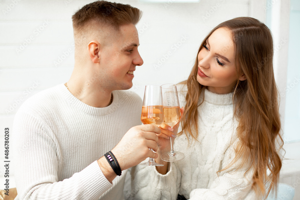 Young beautiful people drink wine from glass glasses celebrating acquaintance. Love at first sight. Romantic relationships. Love and tenderness. Beauty and youth. Young beautiful people drink wine from glass glasses celebrating acquaintance. Love at first sight. Romantic relationships. Love and tenderness. Beauty and youth.