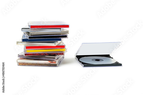 CD in an open box and a stack of discs on a white background