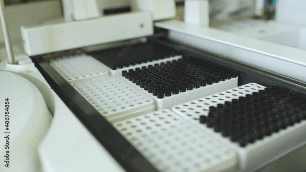 analyzer with containers with test tubes in close-up in a PCR laboratory analyzer with containers with test tubes in close-up in a PCR laboratory