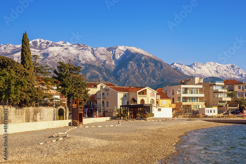 Beautiful winter Mediterranean landscape. Montenegro, Kotor Bay. View of Tivat town and snow-capped Lovcen mountain