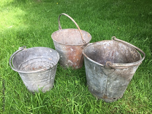 Vintage metal tin buckets in original condition. Used on a farm. With handle. Group of 3.