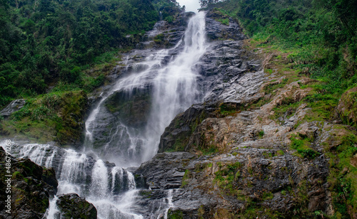 waterfall in the middle of a mountain 