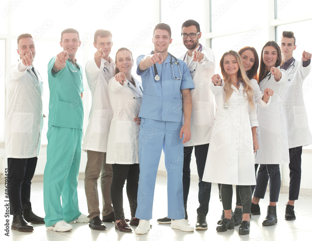 in full growth. successful medical professionals are pointing at you in full growth. successful medical professionals are pointing at you
