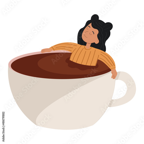 Young woman laying in a big cup of coffee.