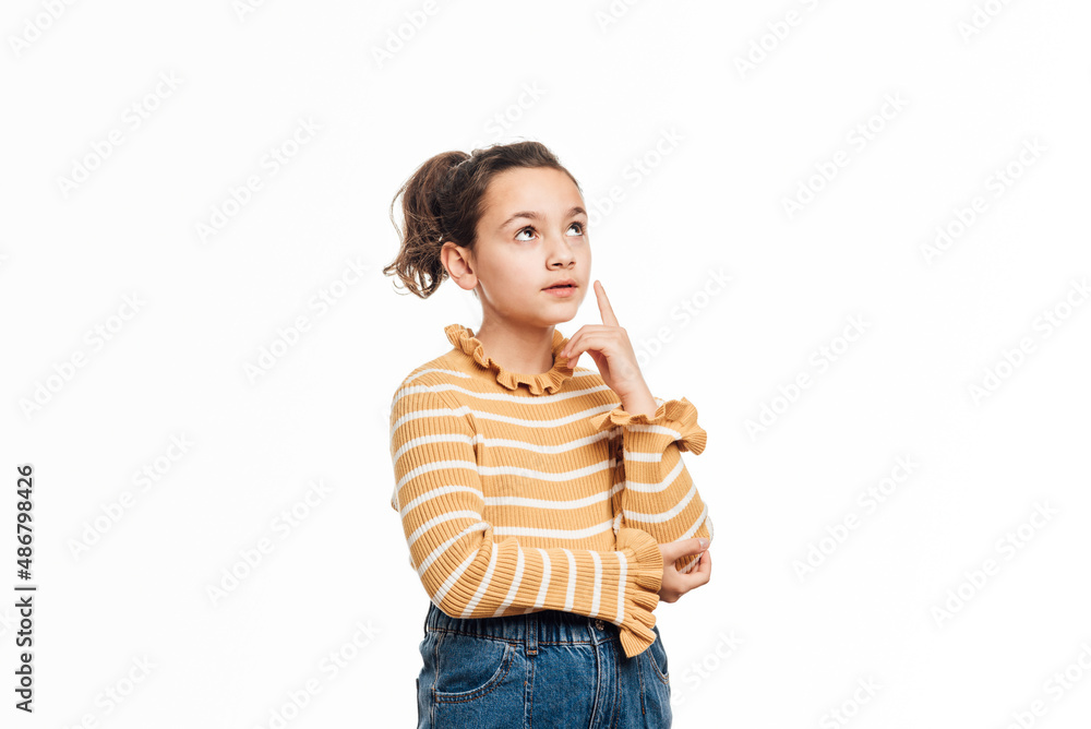 Thoughtful girl thinking about something while standing over an isolated white background. Thoughtful girl thinking about something while standing over an isolated white background.