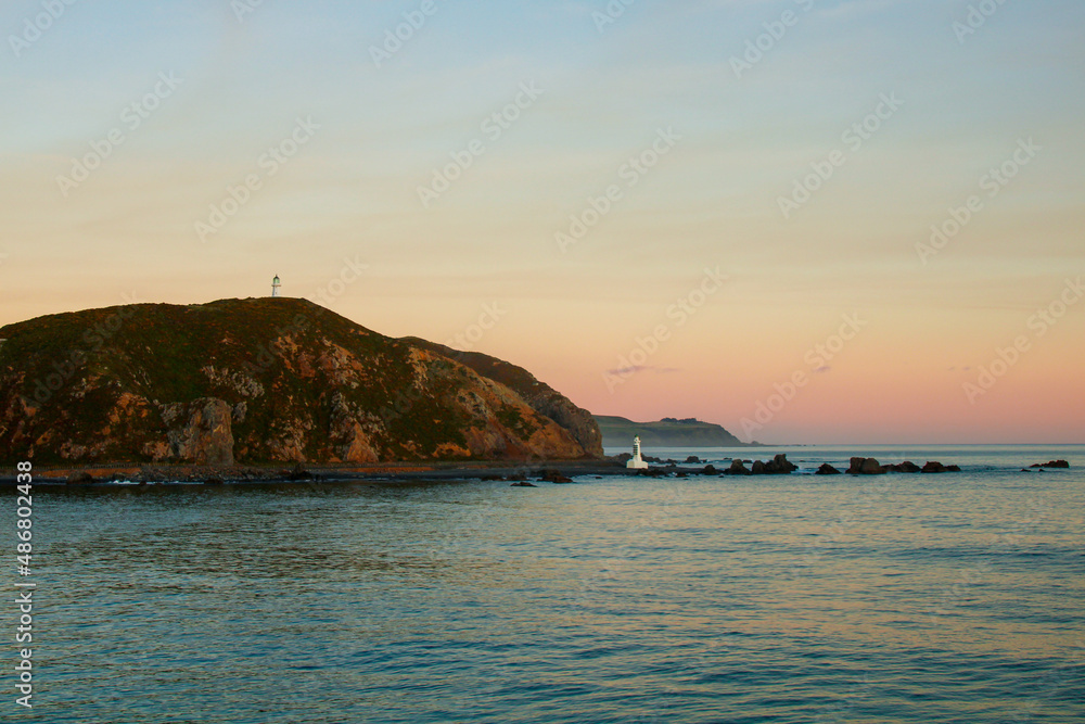 sunset over the sea with lighthouses