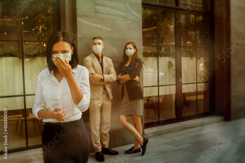 Young woman coughing from the flu or allergic to dust pollution wears a medical mask to protect herself and those around her for public safety.