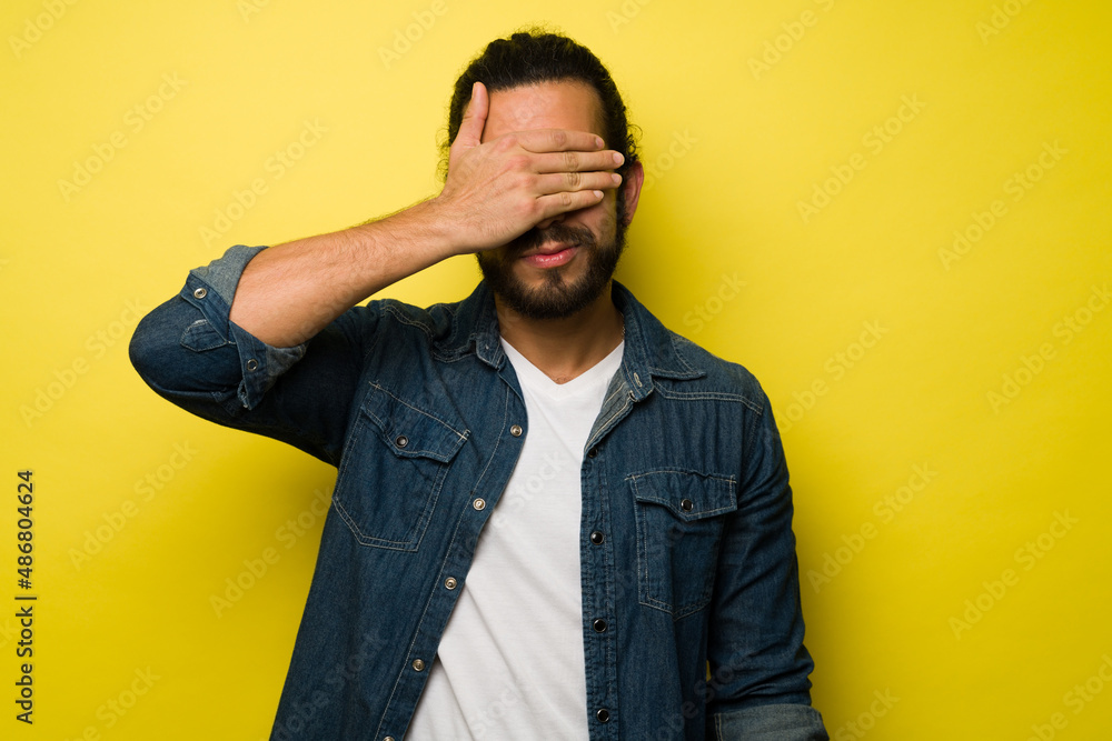 Fototapeta premium Mysterious man against a yellow background