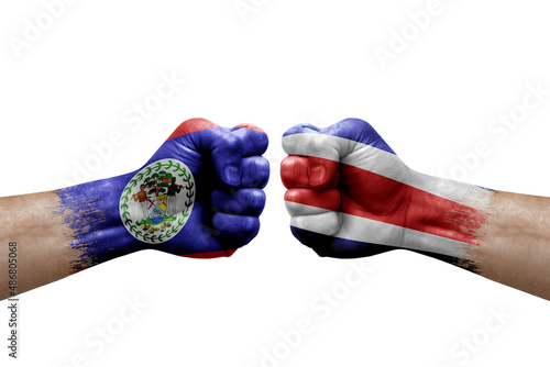 Two hands punch to each others on white background. Country flags painted fists, conflict crisis concept between belize and costa rica