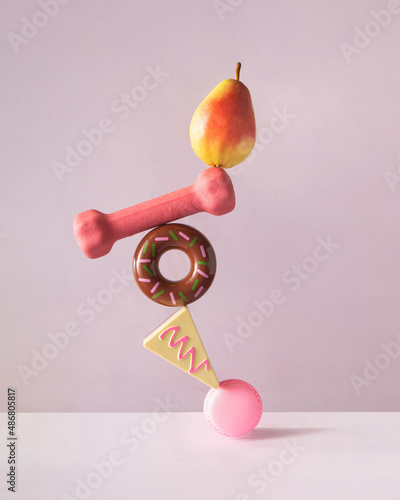 Creative balanced lifestyle concept. Minimalistic composition with sweets, fruit and workout on pastel purple background. Eating healthy food idea.