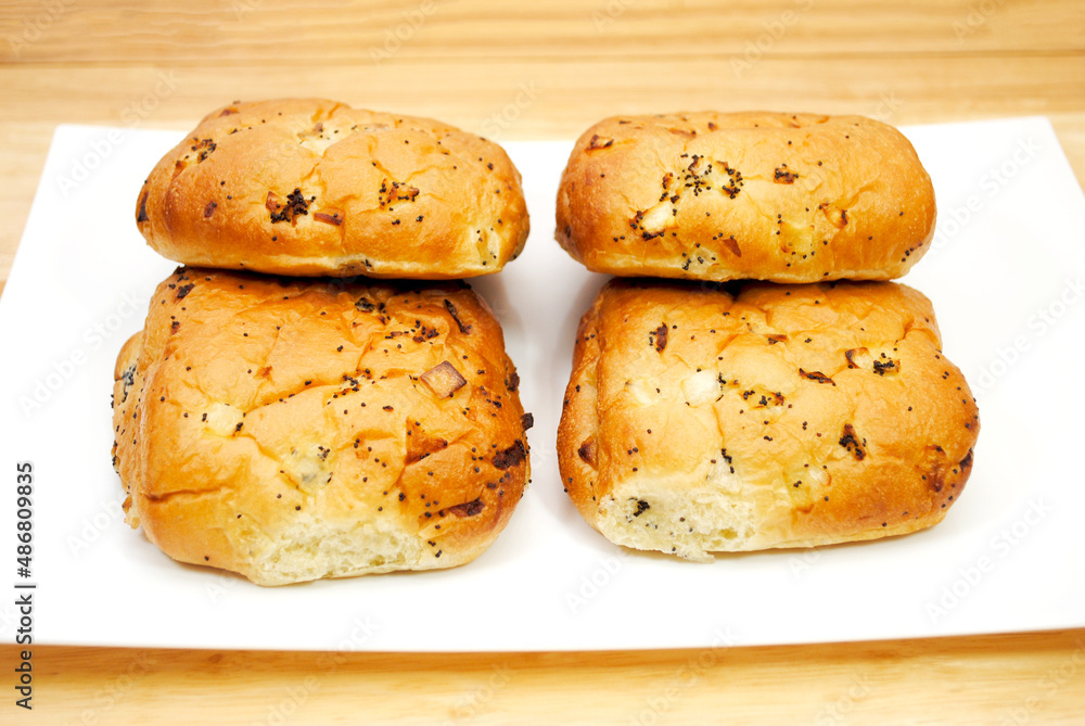 Four Onion Rolls on a White Platter Four Onion Rolls on a White Platter