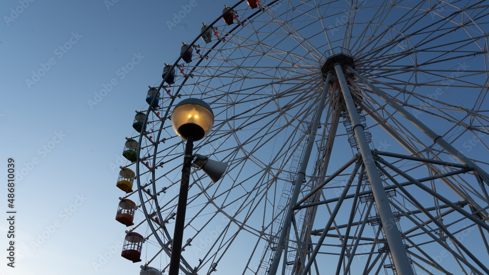 Ferris wheel and streetlights at dusk Ferris wheel and streetlights at dusk
