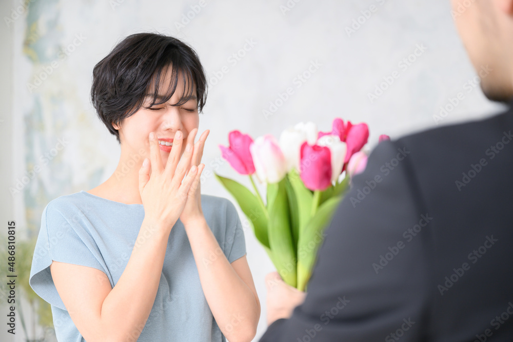 A lovely woman is pleased with her bouquet of flowers. A lovely woman is pleased with her bouquet of flowers.