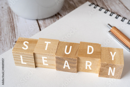 Foto 「STUDY」「LEARN」と書かれた積み木、ペン、ノート、コーヒーカップ