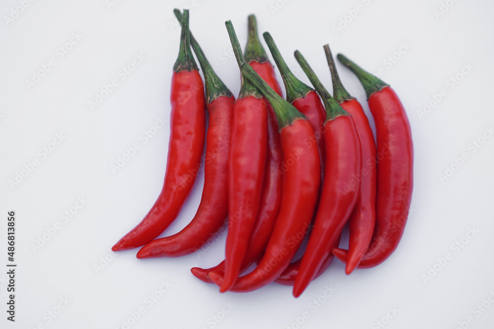 Red hot chili on white background. Concept : Food ingredient. Organic vegetable for cooking. Agriculture crops in Thailand that Thai farmers grow for sale, cook spicy food.          