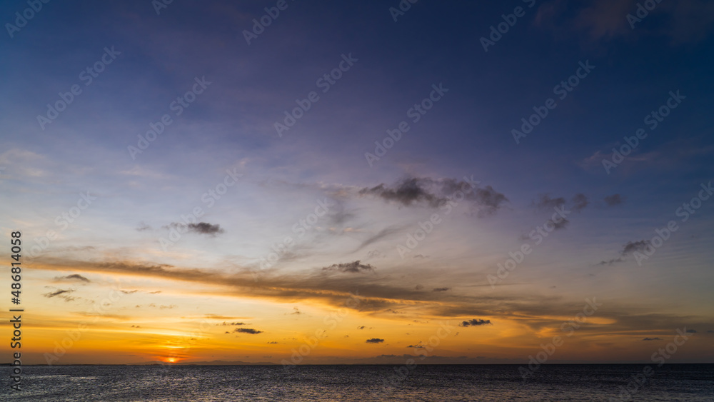 Fototapeta premium Dusk, Sunset sky over sea in the evening on twilight with orange sunlight