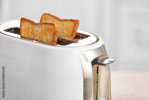 White toaster with bread slices on counter kitchen, closeup