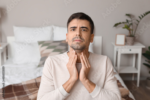 Ill young man with sore thr...