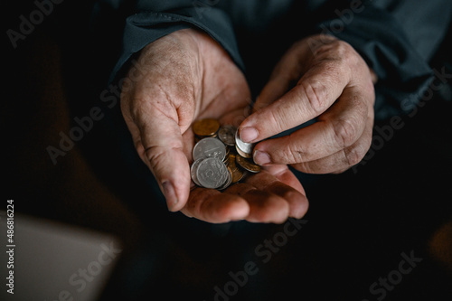 dirty hands of an old woman holding coins. a crisis. default. poverty