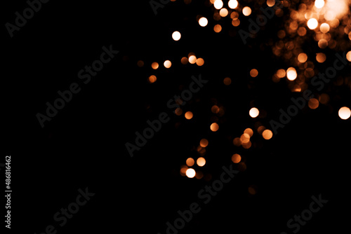 Falling blurred sparks against black background. overlay layer