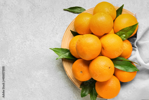 Plate with fresh juicy oranges on white background © Pixel-Shot