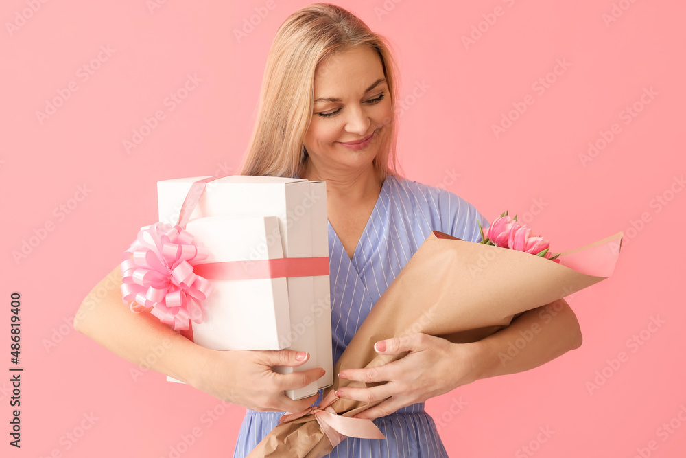 Woman with gift boxes and bouquet of tulips on color background. International Women's Day celebration Woman with gift boxes and bouquet of tulips on color background. International Women's Day celebration