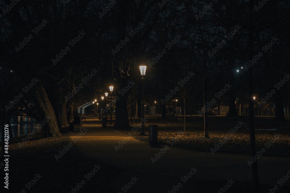 illuminated sidewalk from street lights in prague downtown at night