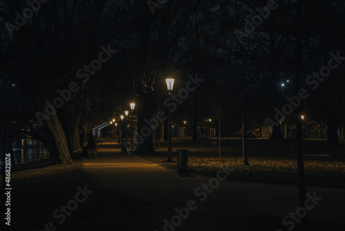 illuminated sidewalk from street lights in prague downtown at night