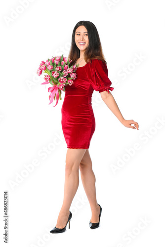 Beautiful young Asian woman with flowers on white background. International Women's Day celebration