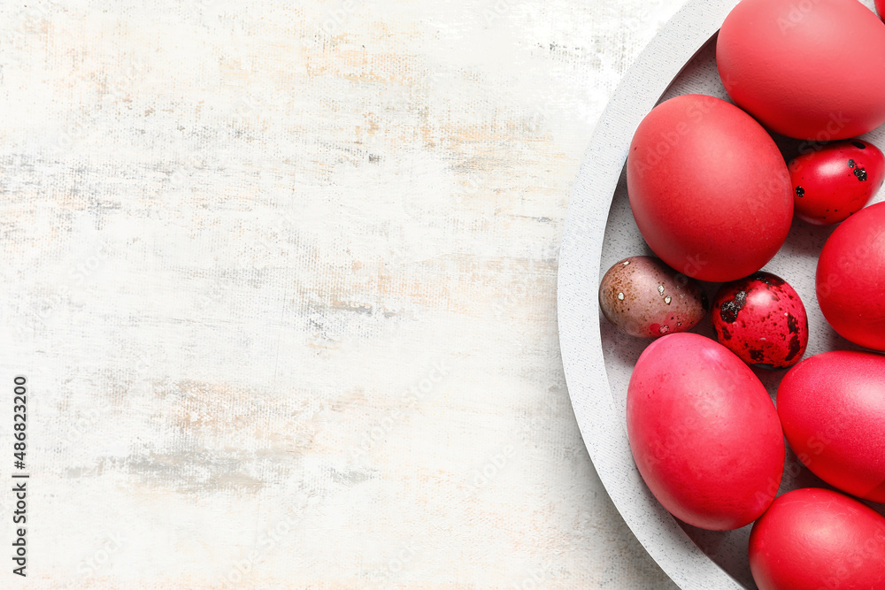 Plate with different Easter eggs on grunge background Plate with different Easter eggs on grunge background