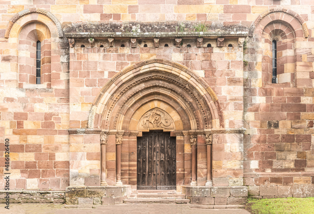 Naklejka premium Facade of ancient stone Romanesque church entrance