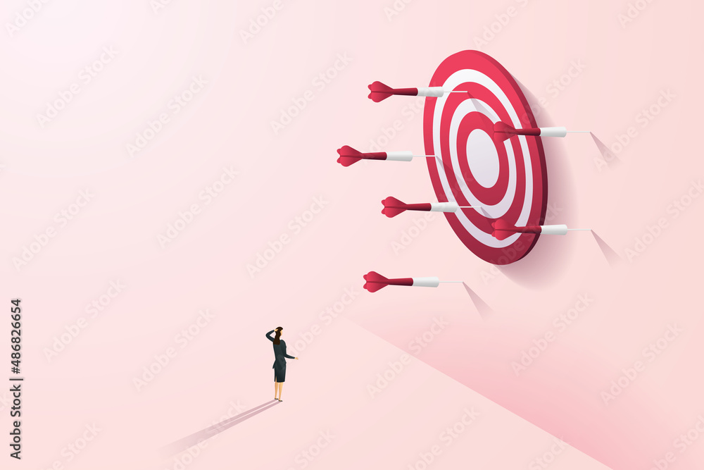 Woman watching The dart that missed the target on the pink wall. Woman watching The dart that missed the target on the pink wall.
