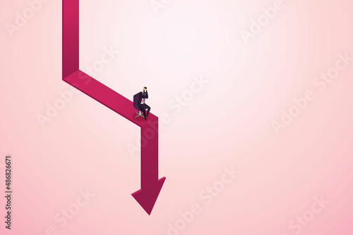 Businessman sit on a falling arrow chart.