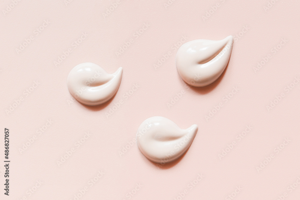 Pink cream swatches pastel background. Face creme, body lotion smears. Skincare product texture Pink cream swatches pastel background. Face creme, body lotion smears. Skincare product texture