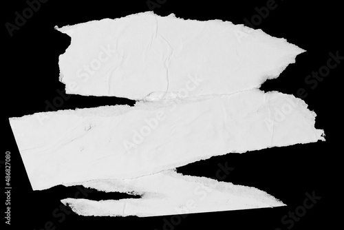 White paper ripped pieces isolated on black background. Dirty wrinkled glued paper poster texture