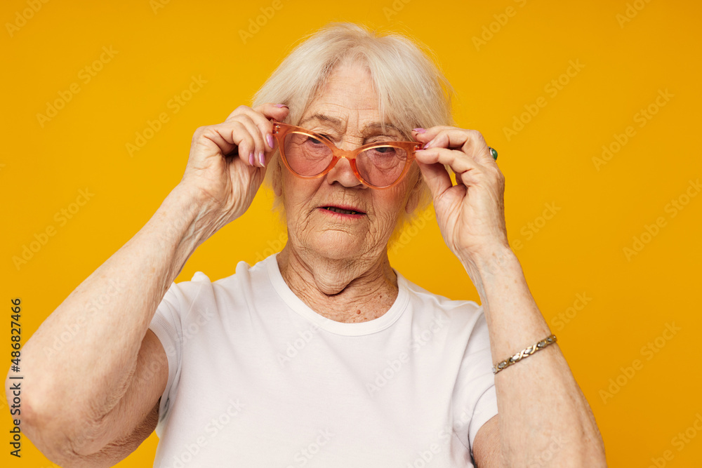 Portrait of an old friendly woman health lifestyle eyeglasses isolated background Portrait of an old friendly woman health lifestyle eyeglasses isolated background